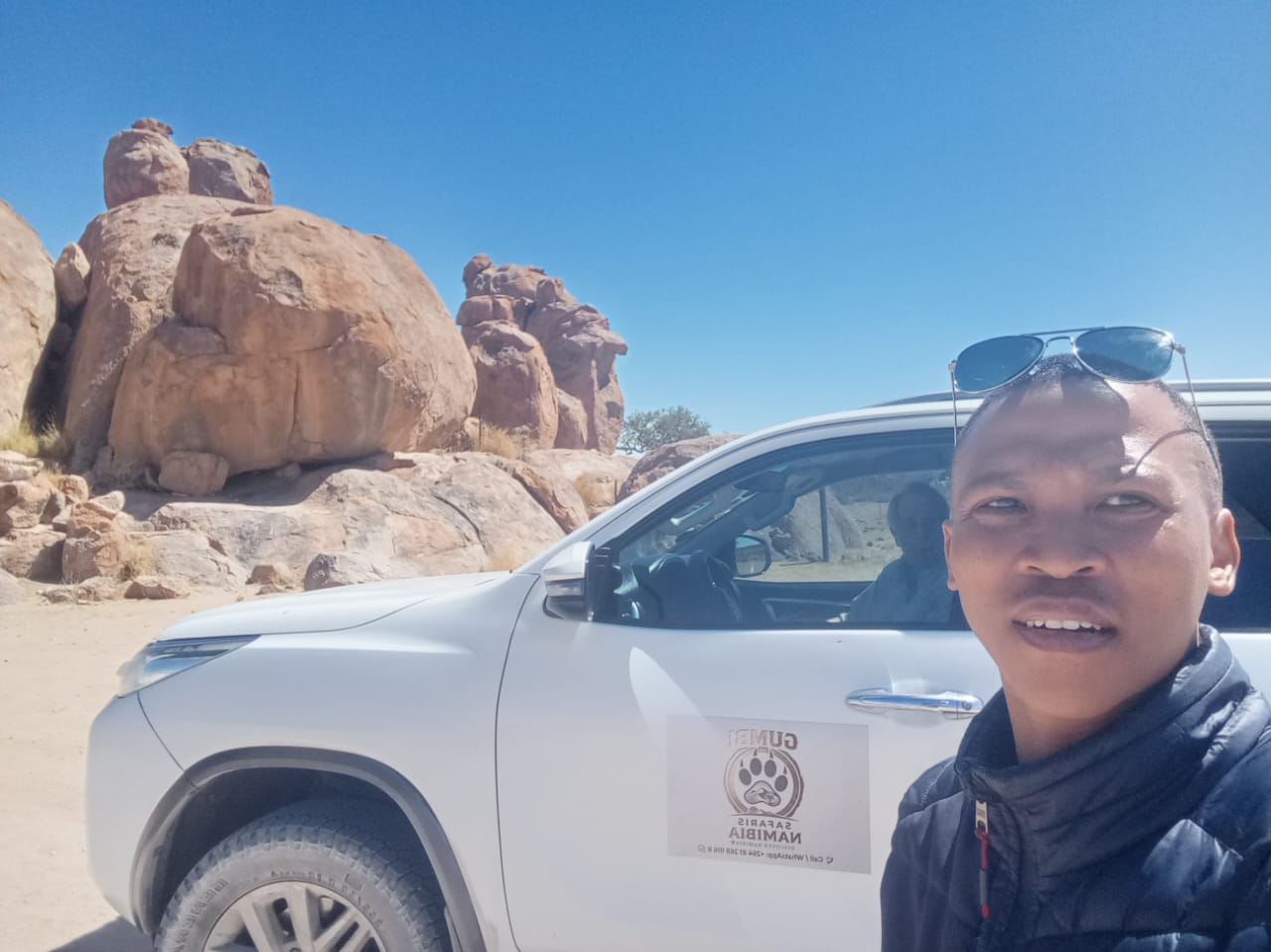 Guide beside safari vehicle